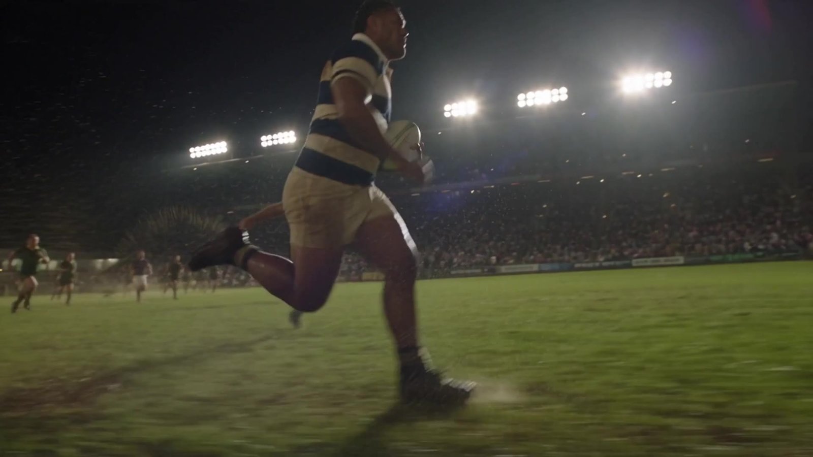 Still from the brand film: an athlete at rest, looking into the lens at golden hour
